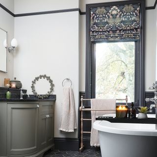 Bathroom with white walls and dark details