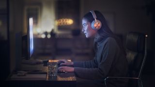 a photo of a woman using the Beoplay Portal PC PS