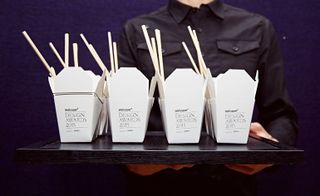 Waiter holding a tray of ‘chinmi’, Japanese delicacies served in miniature takeaway cartons