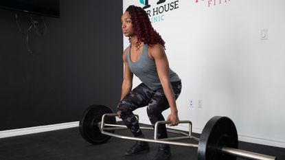 Woman doing a deadlift with a trap bar