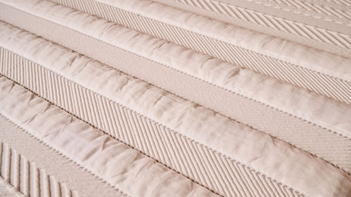 A closeup of the textured stripes on the cover of the Leesa Legend Hybrid Mattress