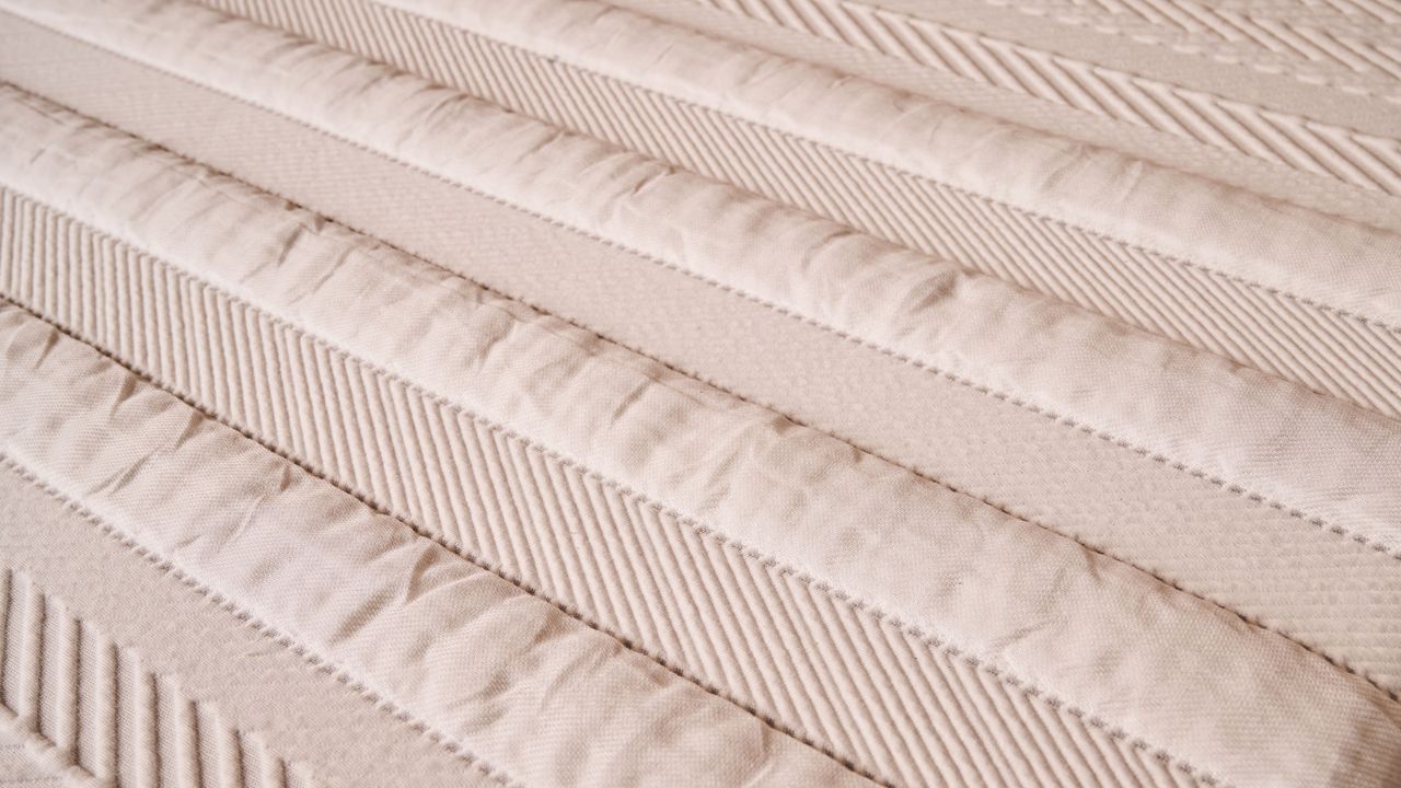 A closeup of the textured stripes on the cover of the Leesa Legend Hybrid Mattress