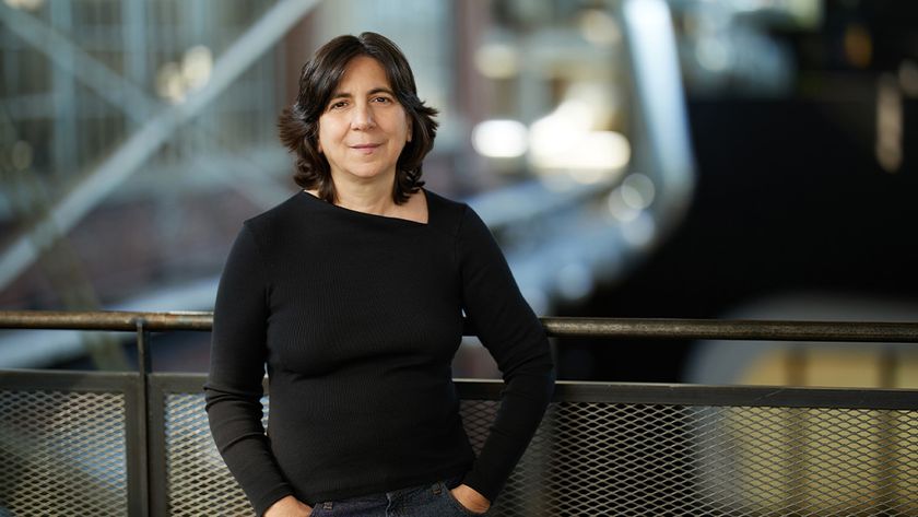 AU 2025; a woman stands in front of a metal railing