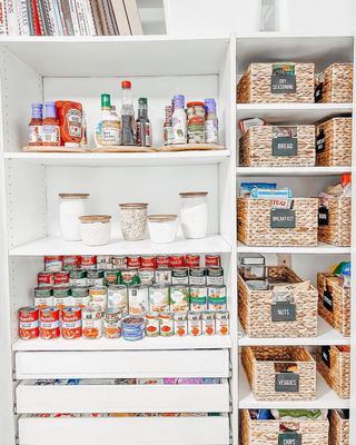 A kitchen pantry with baskets on the shelves