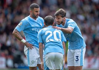 Ruben Dias of Manchester City talks with team mates Kyle Walker and Bernardo Silva during the Premier League match between Sheffield United and Manchester City at Bramall Lane on August 27, 2023 in Sheffield, England. (Photo by Visionhaus/Getty Images)