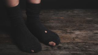A photo of someone wearing socks with holes in them