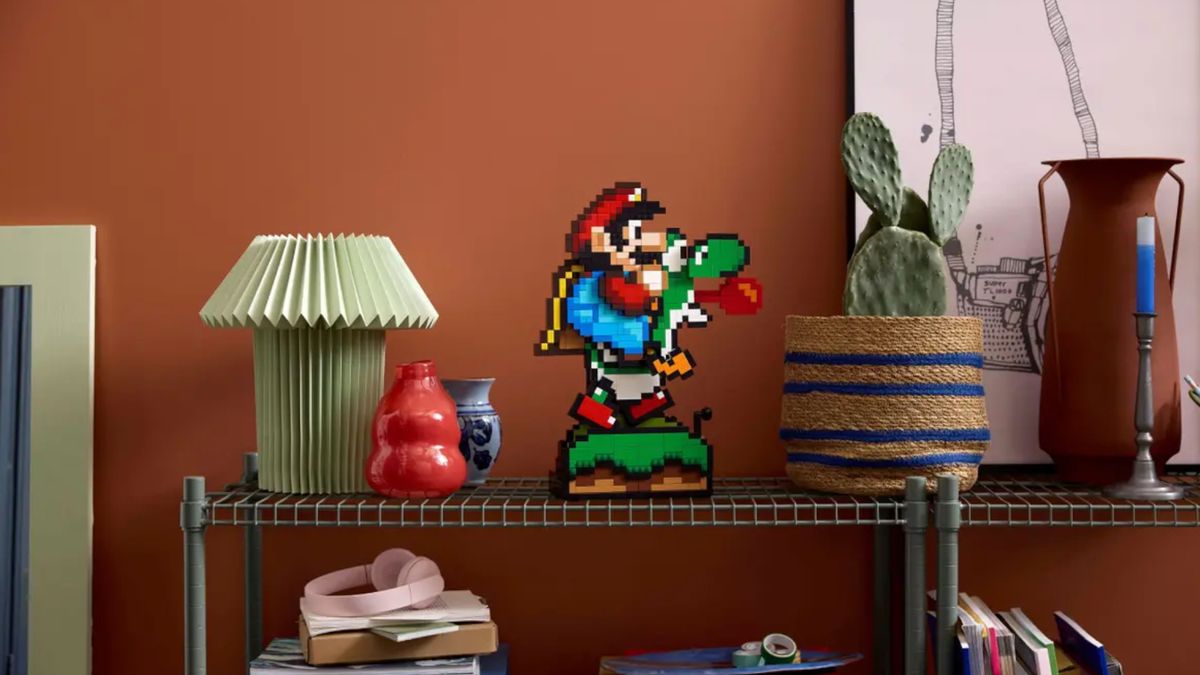 Lego Super Mario World set on a shelf, beside a lamp and pot plant