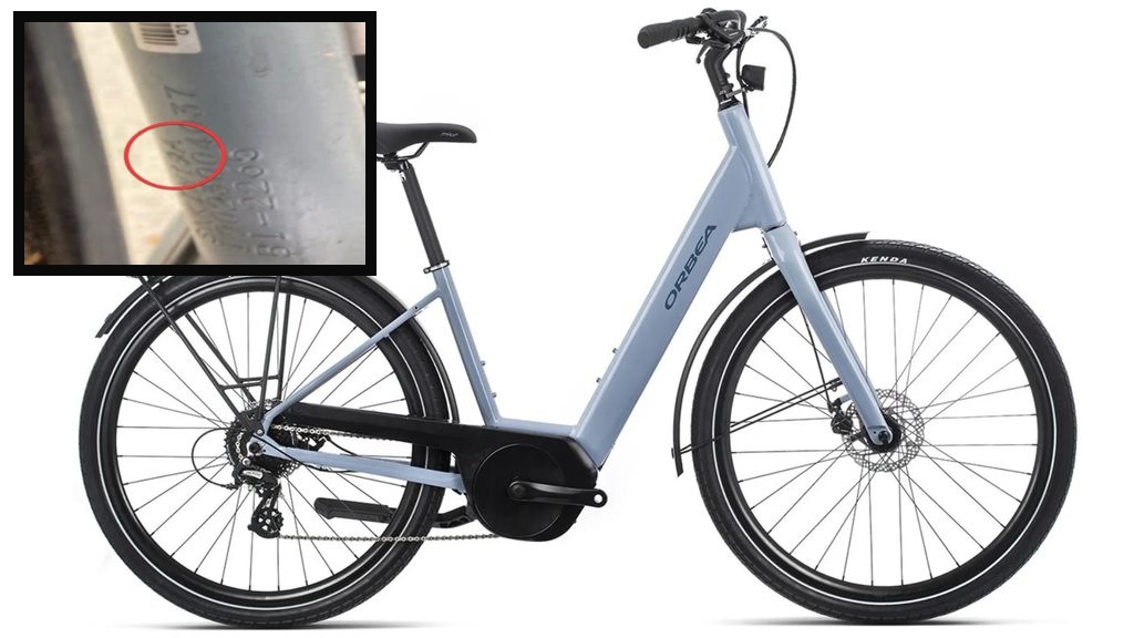 image of the bike, a blue ebike with step through frame and Orbea logo, with overlay of the relevant frame code