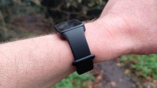 The Xiaomi Smart Band 9 Active being worn in a park.