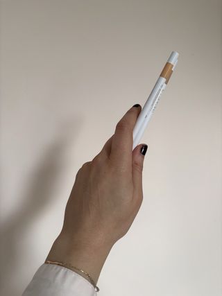 Mica Ricketts showing swatch of Lisa Eldridge Pinpoint Concealer Micro Correcting Pencil