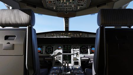 A shot of a cockpit, looking out the front window of an aircraft