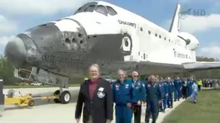 Veteran astronauts escort space shuttle Discovery to its new home at the Smithsonian's National Air and Space Museum annex on April 19, 2012. Discovery, NASA's oldest and most traveled shuttle, will be displayed at the museum's Steven F. Udvar-Hazy Center in Chantilly, Va.