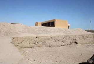 A bulldozer cut into part of the ancient city of Hamoukar by contractors building an addition to a school. Without protection at the site, modern-day buildings are being erected over it. Shot taken in April 2012.