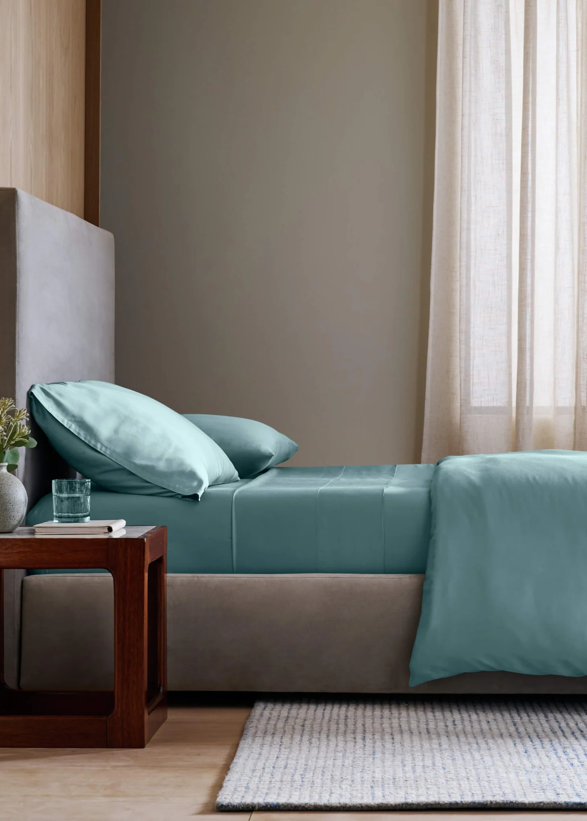 A bedroom with a bed in blue bamboo bedding