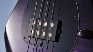Close up of bass guitar strings and pickup