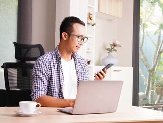 Man working from home on two devices