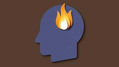 A paper silhouette of a head with a paper flame over where the brain would be, to indicate burnout on a brown background.