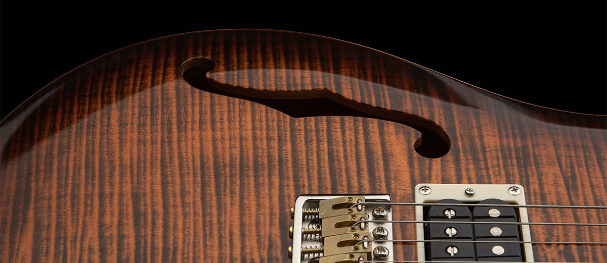 A detail photo of the PRS SE Custom 24 Semi-Hollow Piezo in Orange Tiger Smokeburst finish