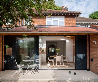 large rear brick extension with sliding doors and overhang