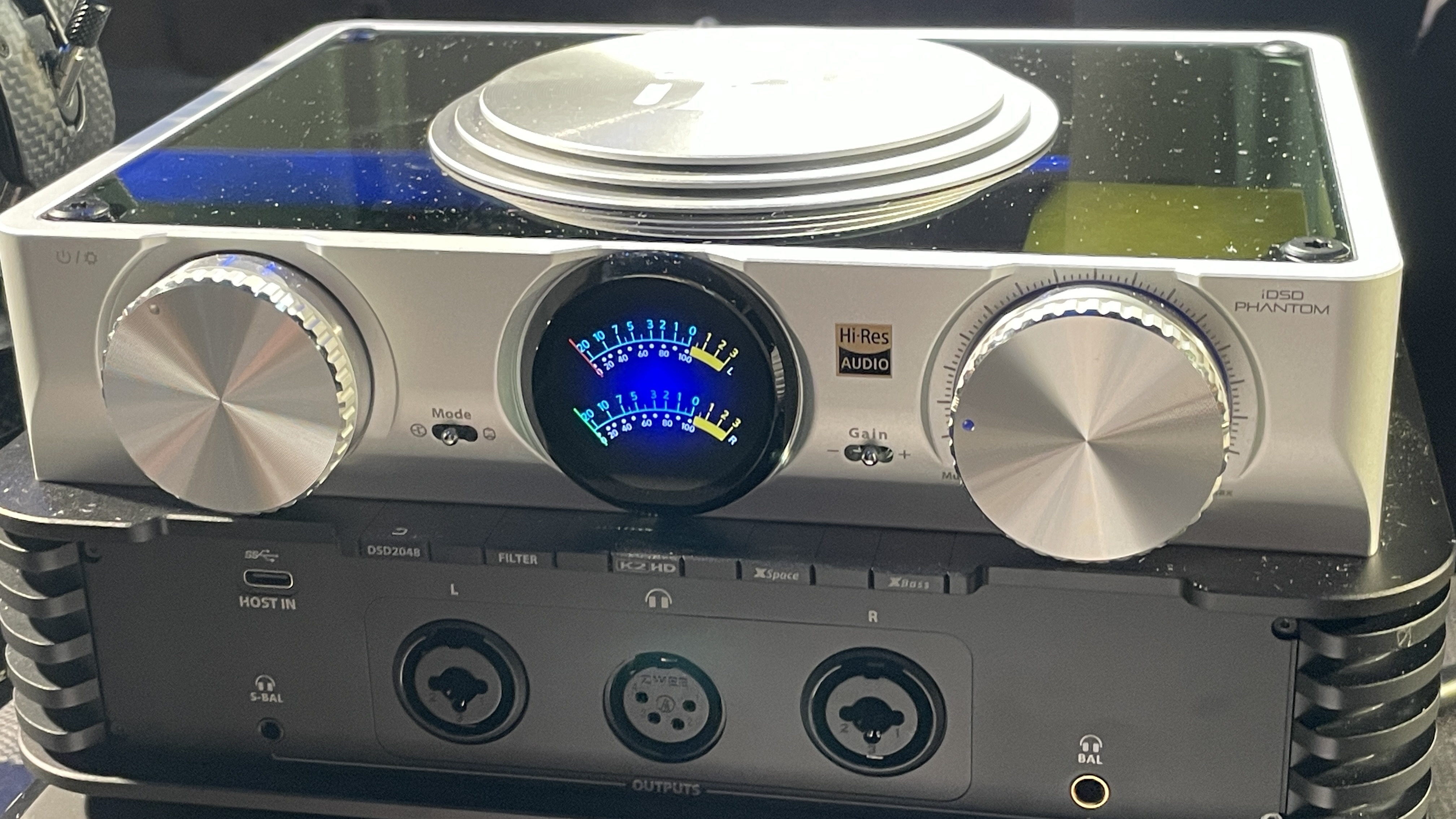 The formidable iFi iDSD Phantom in Tower Bridge, London, used with headphones and illuminating the front panel 
