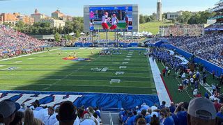 Kansas David Booth Kansas Memorial Stadium has a new video board and LED ribbon for a packed house of college football fans.