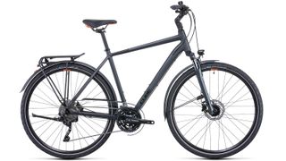 A side view of the Cube Touring EXC Urban Bike with flat bars, a rear rack, dynamo lights and kickstand