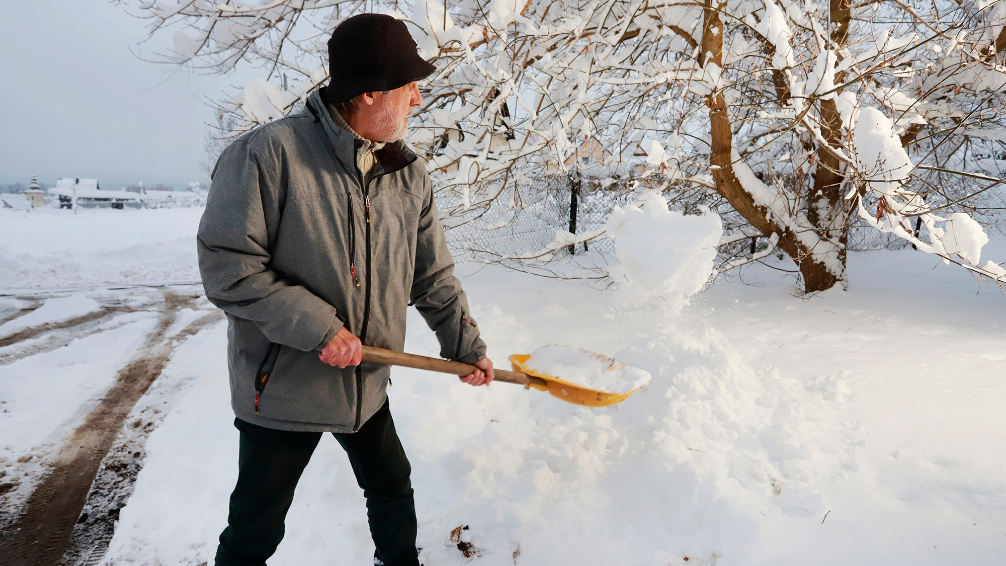 Man is removing snow after the snowfall. ; Shutterstock ID 2705609075