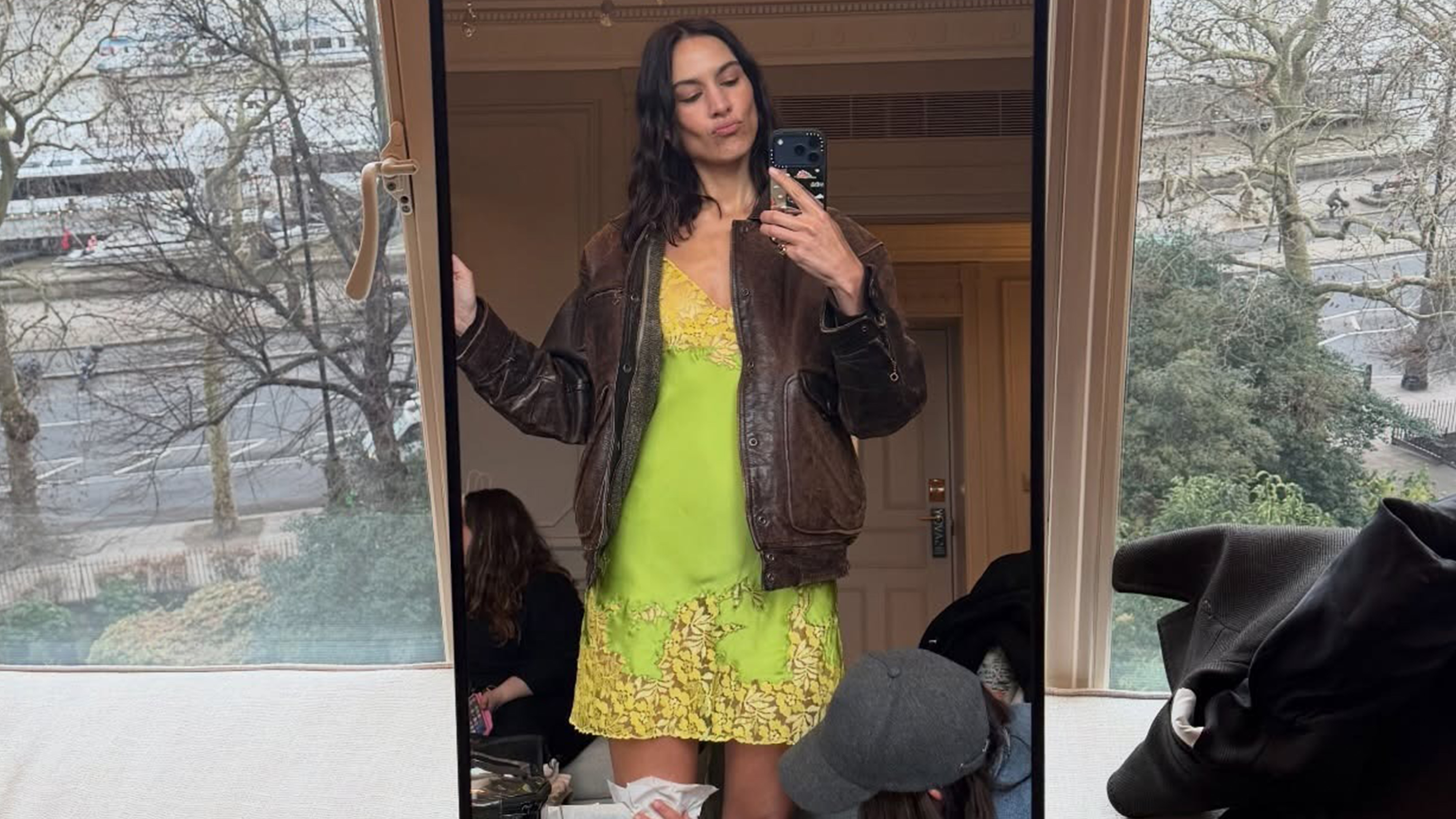 Alexa Chung in London wearing a lace slip dress with high heels.
