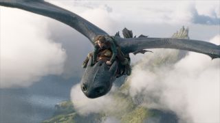 Mason Thames flies through the sky on Toothless in How To Train Your Dragon (2025).