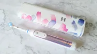 Oral-B Genius X electric toothbrush with its charging case