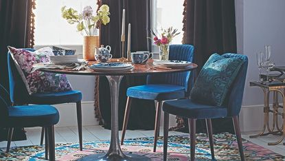 dining room with round table and blue chairs