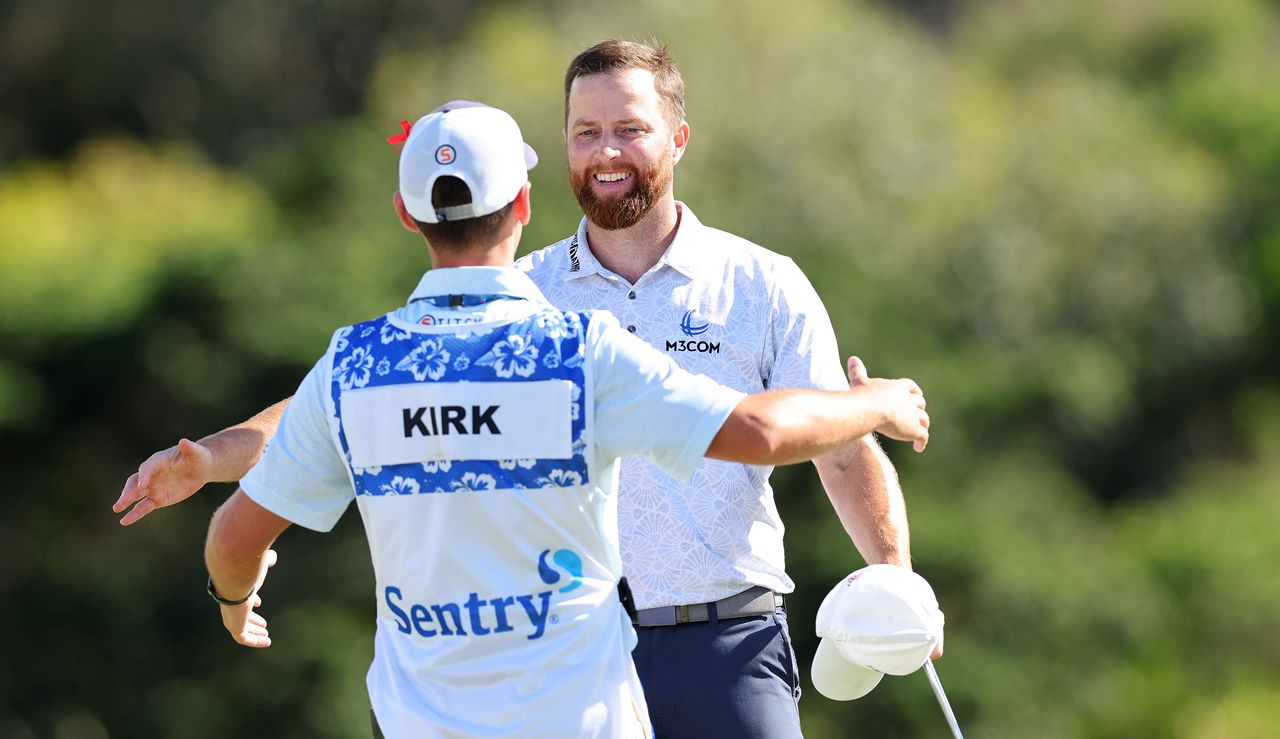 Chris Kirk hugs his caddie on the 18th green after his victory