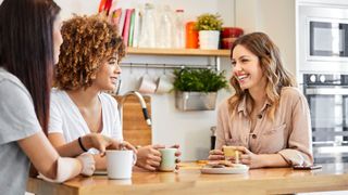 three friends sitting around a breakfast table