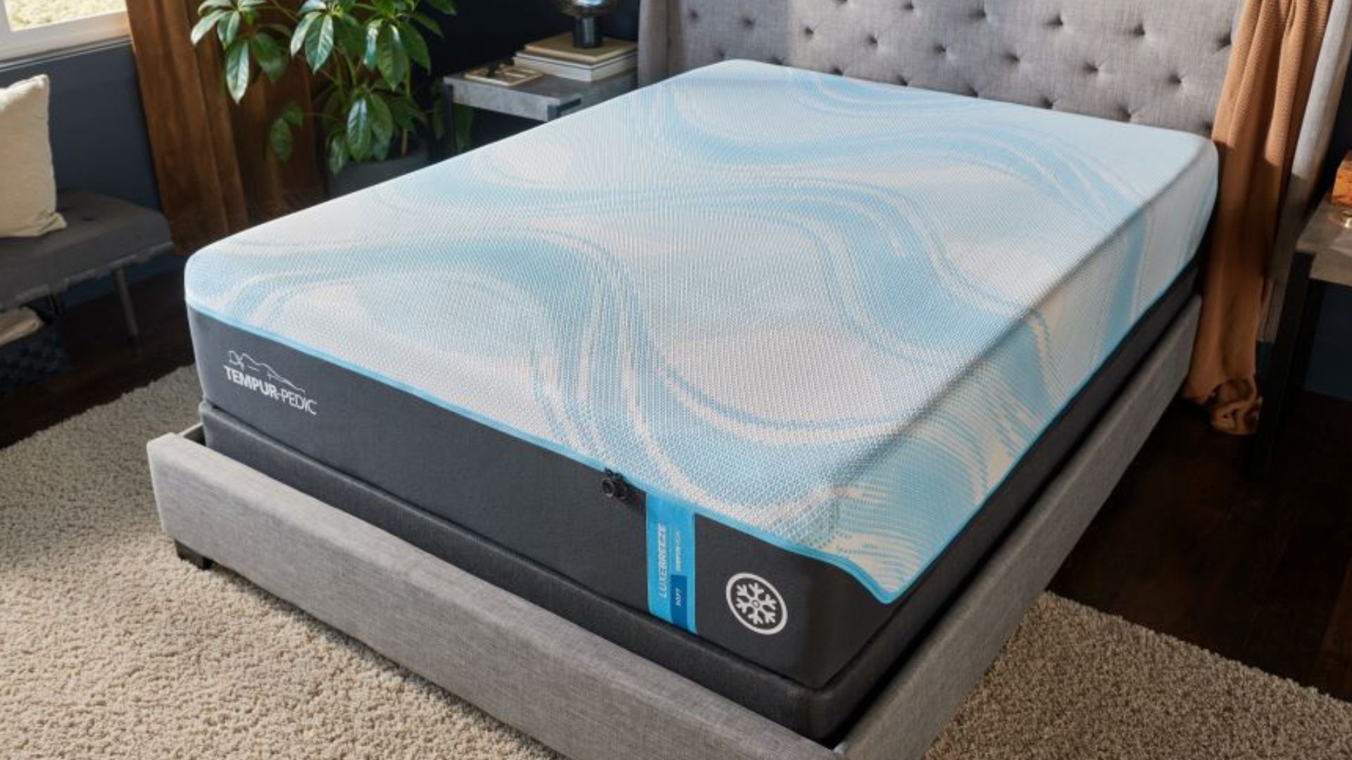 The image shows the Tempur-Pedic Tempur Breeze Luxe mattress on a grey bed foundation in a neutrally decorated bedroom