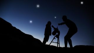 man and son using a telescope