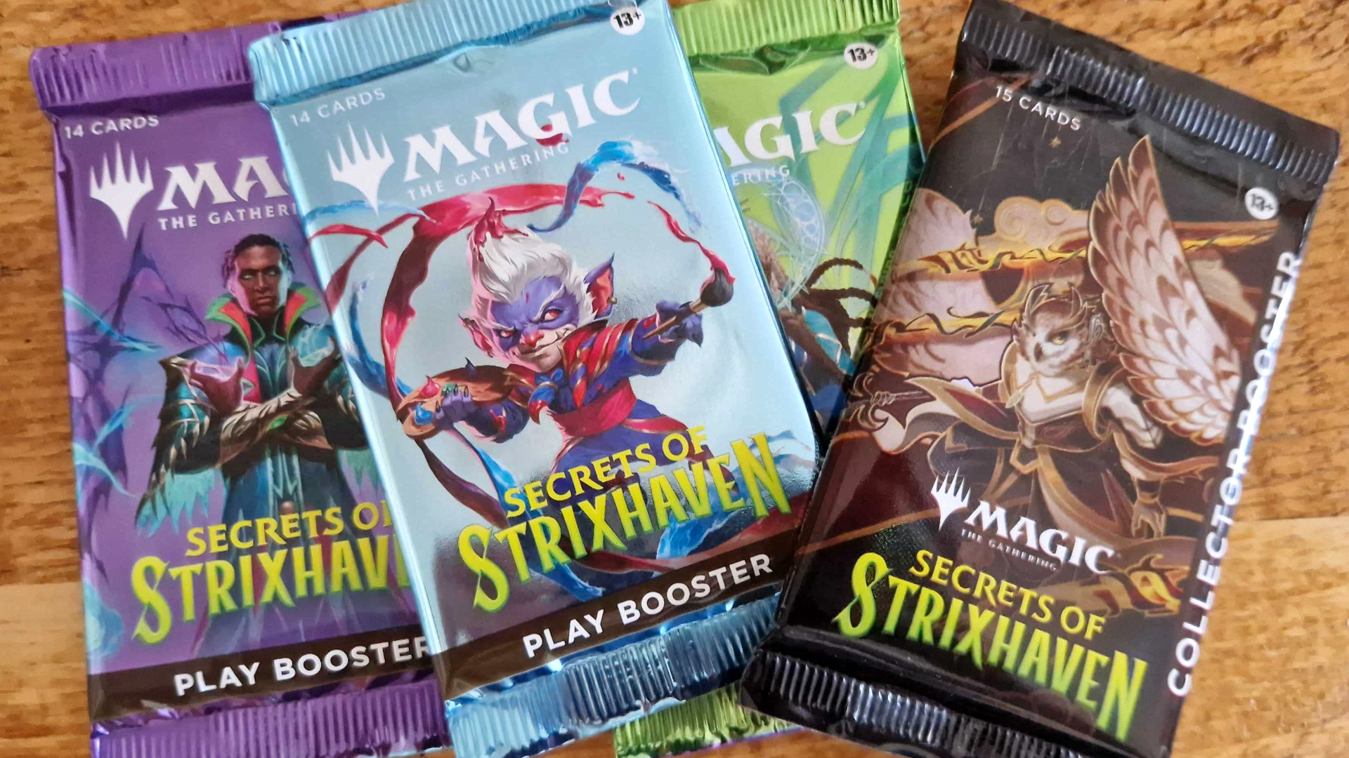 MTG Secrets of Strixhaven booster packs on a plain background