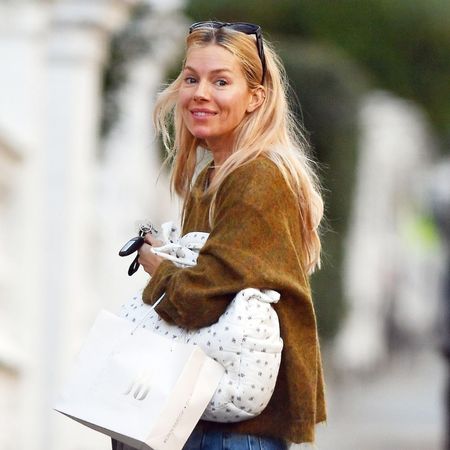 Sienna Miller wears frayed hem jeans.