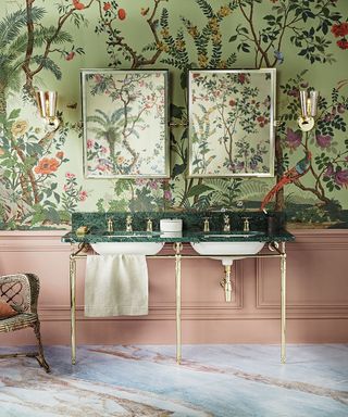 A green oriental wallpaper with pink panelling, double sink and mirrors.