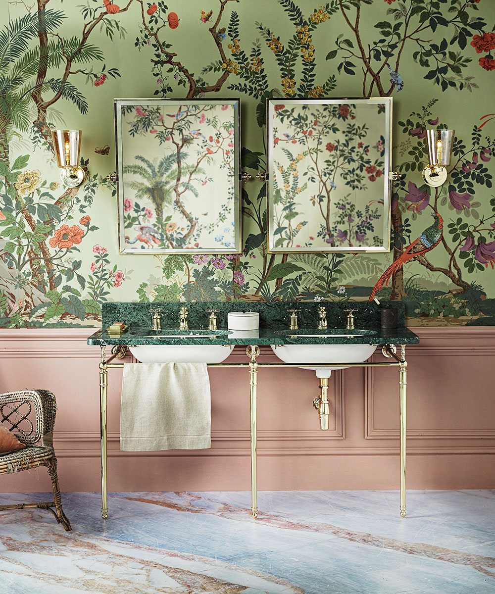 A green oriental wallpaper with pink panelling, double sink and mirrors.