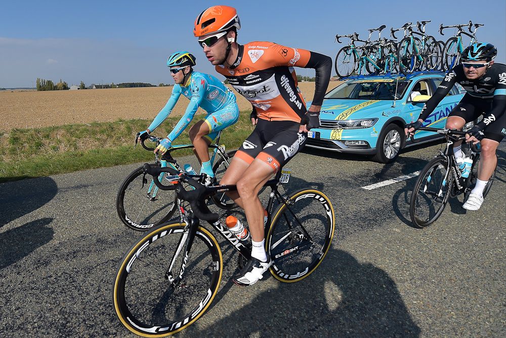A riders grabs some food during Paris-Tours