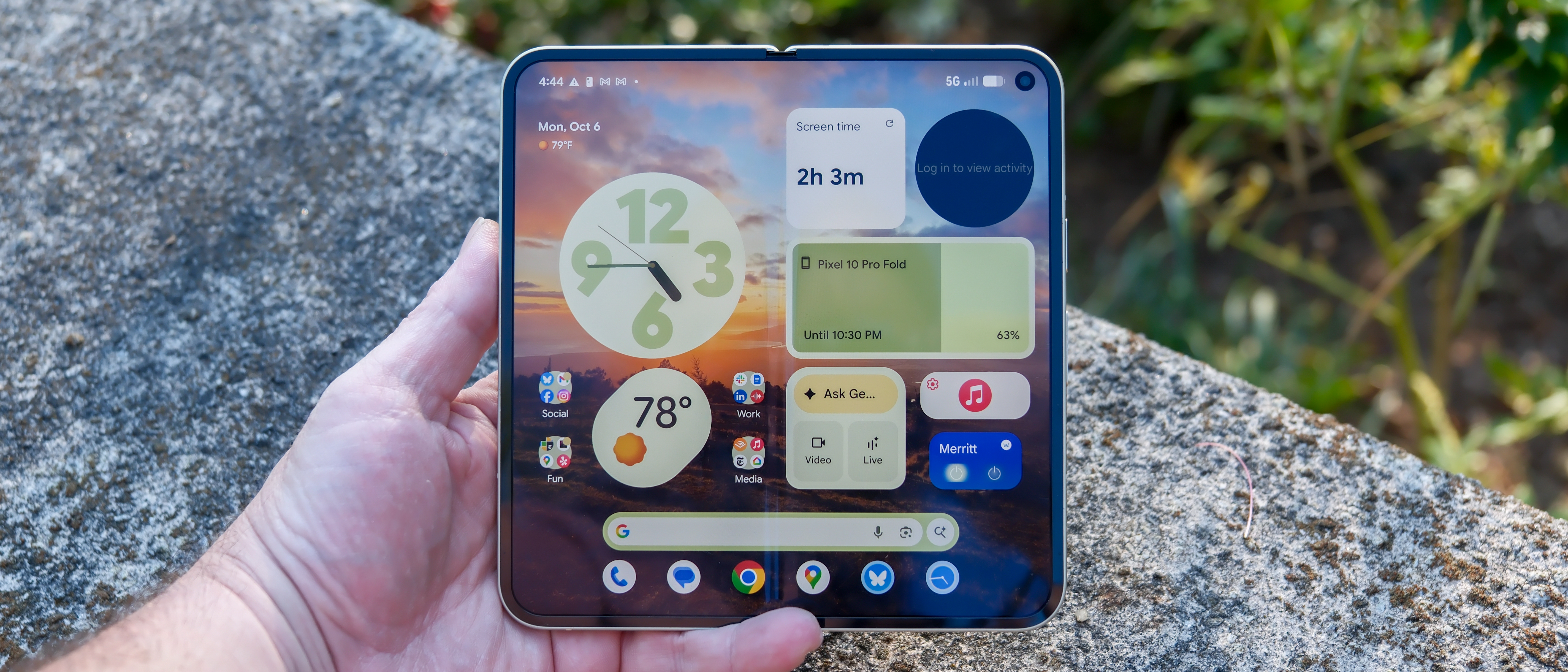 Google Pixel 10 Pro Fold in Jade green outside at a flower garden on a sunny day