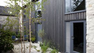 vertical stained timber cladding on a contemporary self build