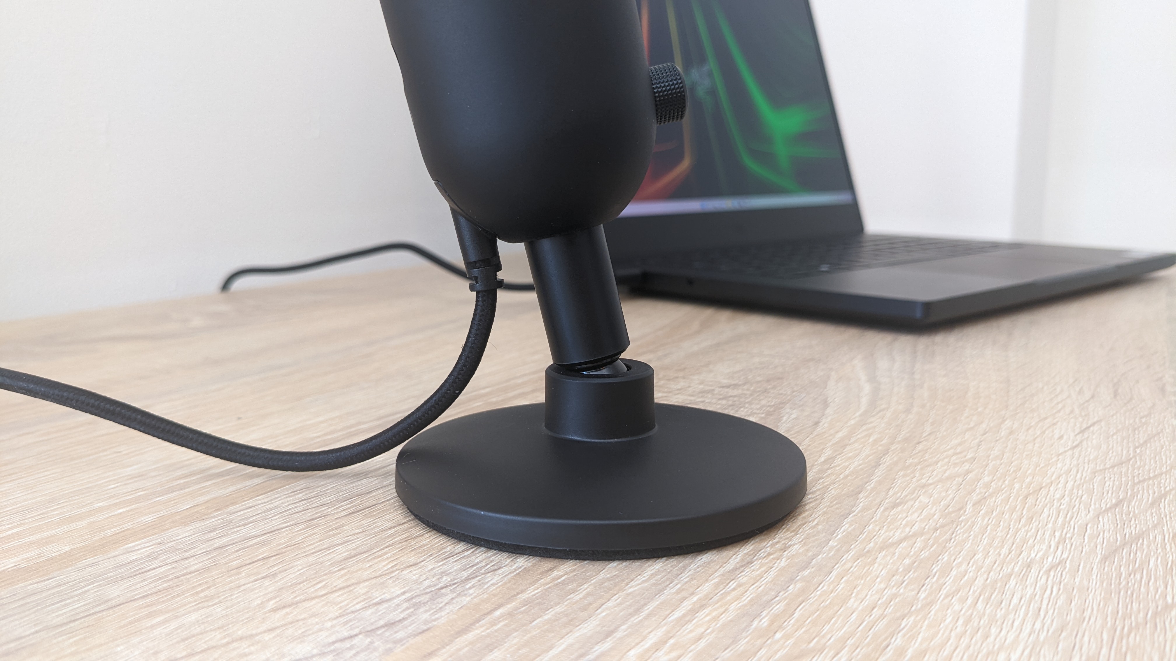 Razer Seiren V2 X USB microphone on a wooden desk, plugged into a Razer Blade 14 laptop.