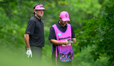 Bubba Watson chats to his caddie