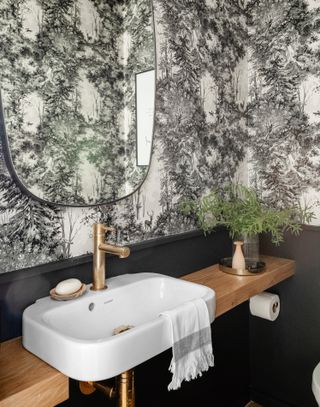 Small bathroom with black and white wallpaper with mirror