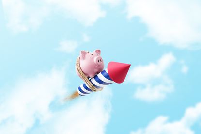 Piggy bank tied to a rocket flying through the air