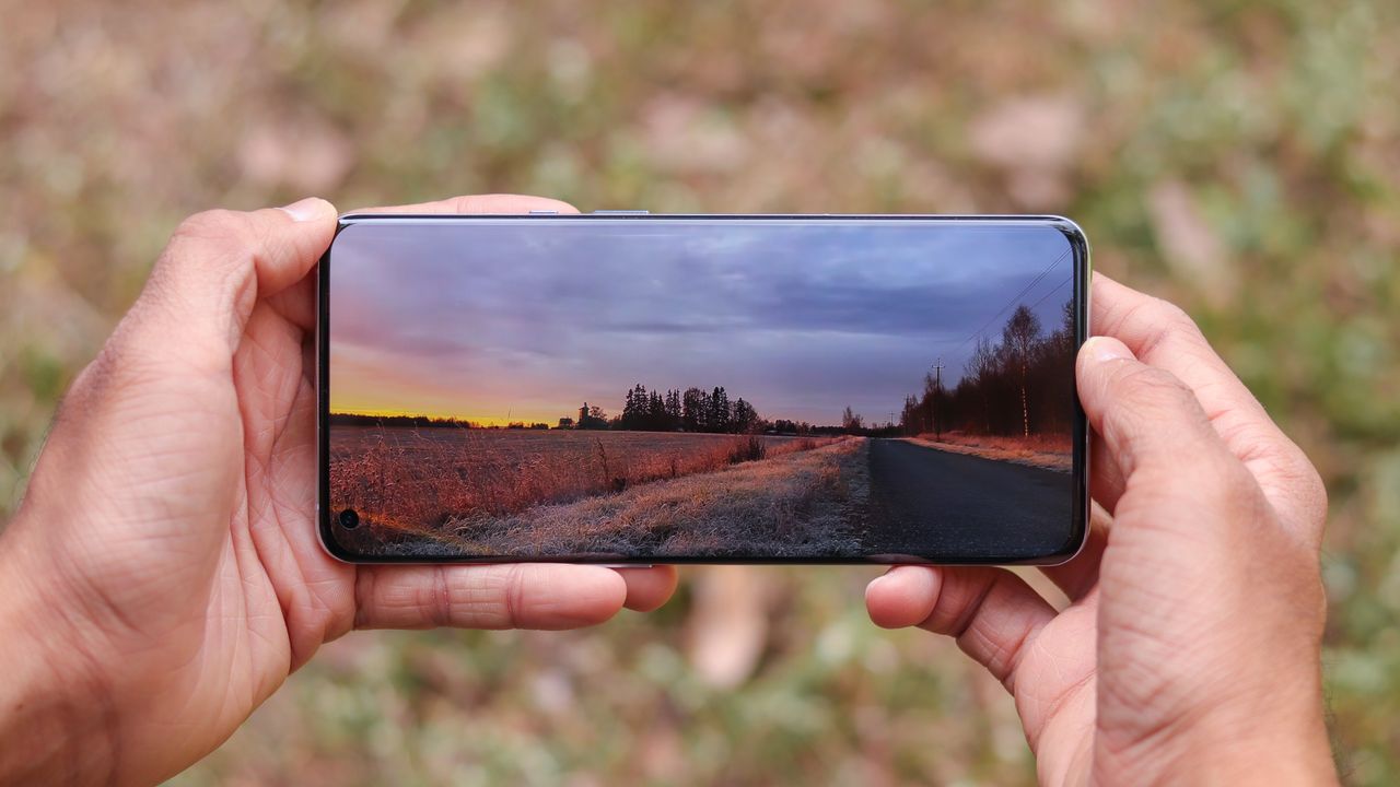 The screen of a OnePlus 9 Pro displaying a colorful landscape