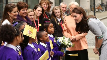 Kate Middleton meets a group of young school children.