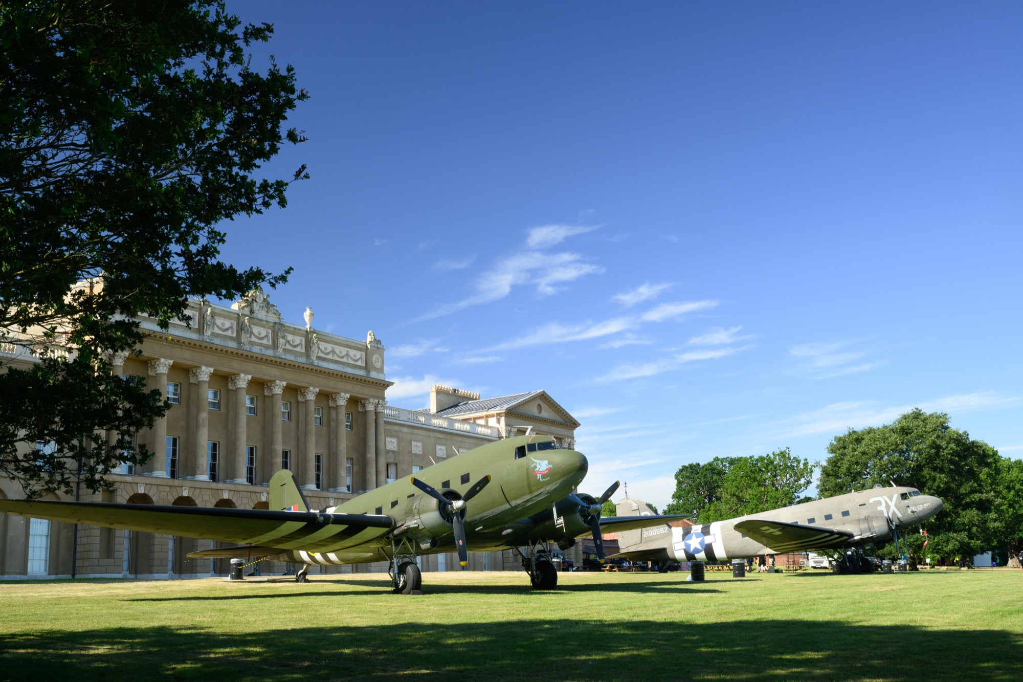 Two C47 Skytrains, in D-Day stripes, in front of Heveningham Hall