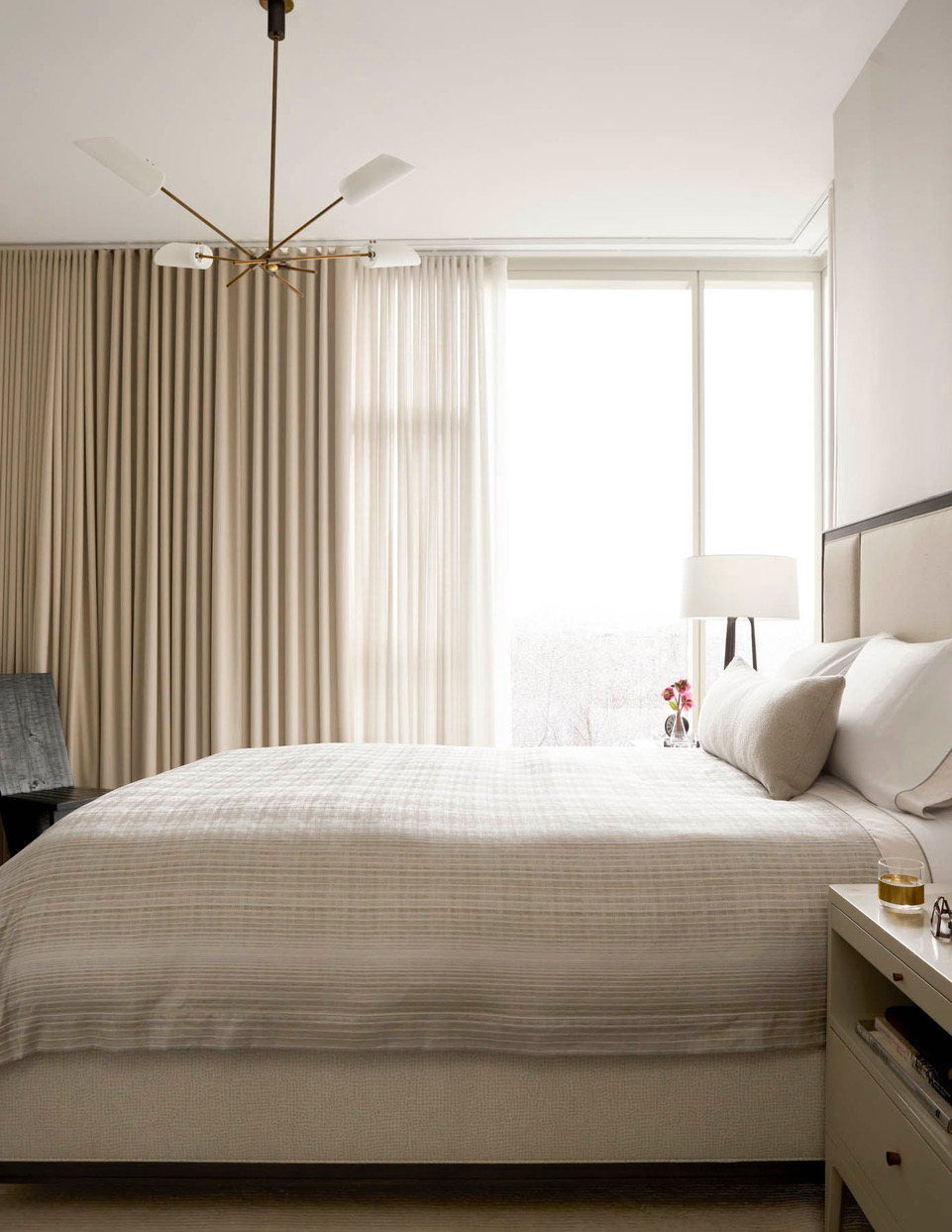 beige bedroom with half open curtain